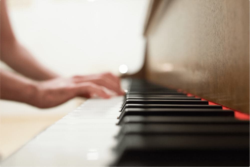 Hands on the piano keys at Eric Liu Piano Studio, San Jose